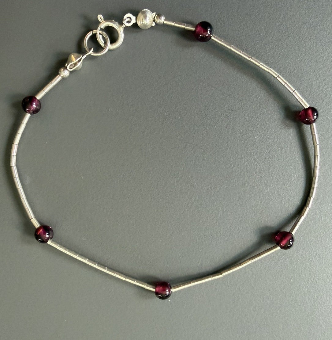 Sterling Silver  Lobster Clasp Bracelet Adorned with Station Garnet (?) Beads.